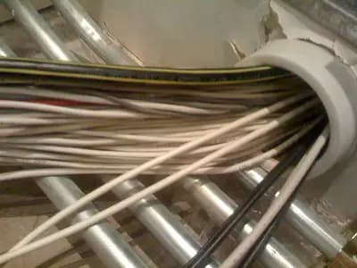 Close-up of tangled fiber optic cabling inside a data center, symbolizing internet infrastructure concentration