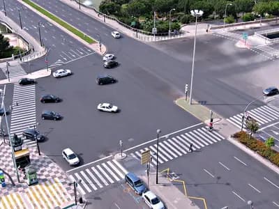 Pedestrians crossing a busy city road at a marked intersection