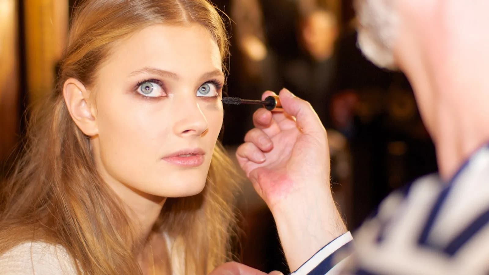 A model having her make-up finished backstage before a Zuhair Murad show in Paris. The house is a guest member of the haute couture calendar
