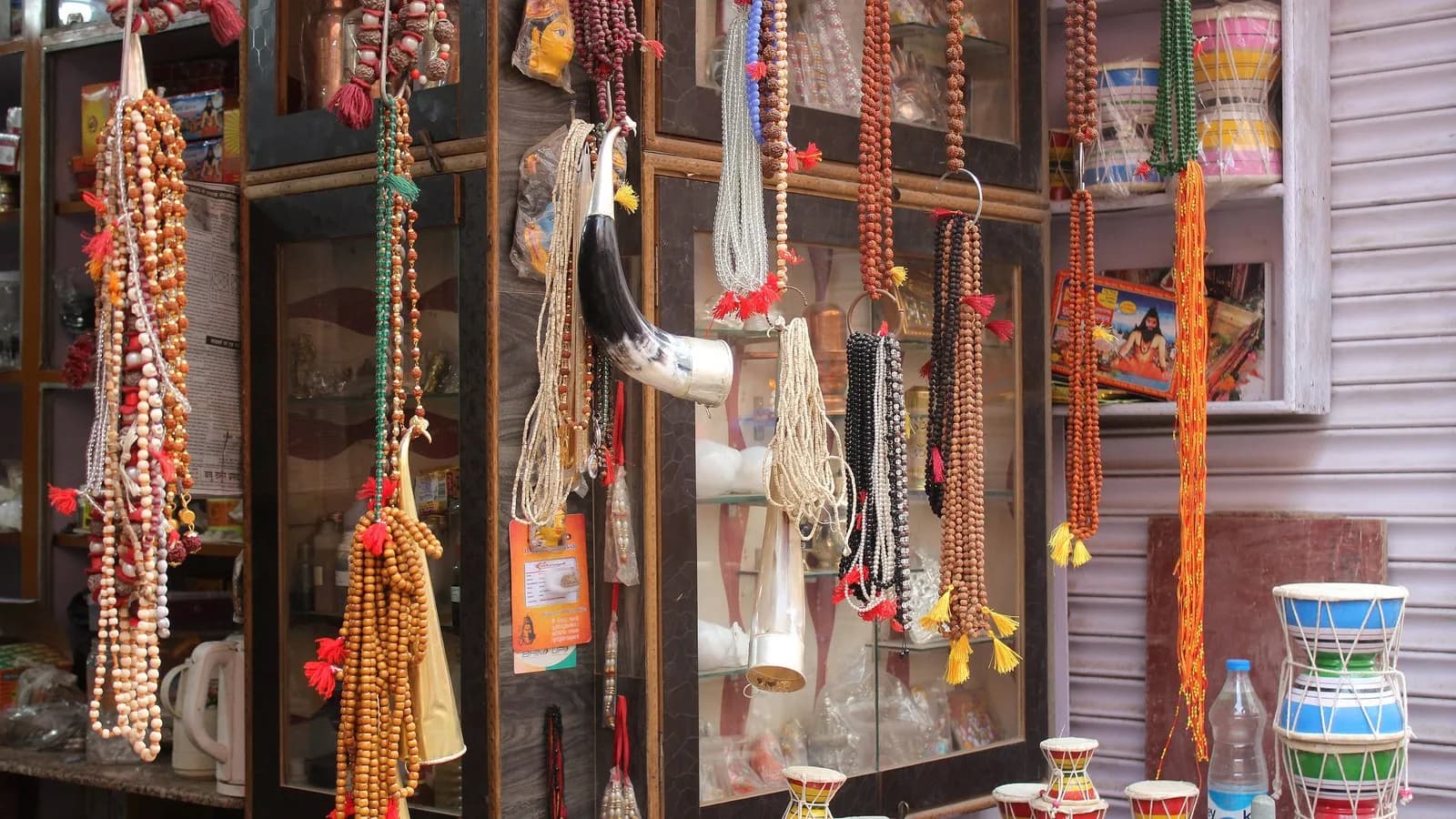 Japa mala, the strings of beads used to count repetitions of a mantra, hanging for sale at a shop in Varanasi