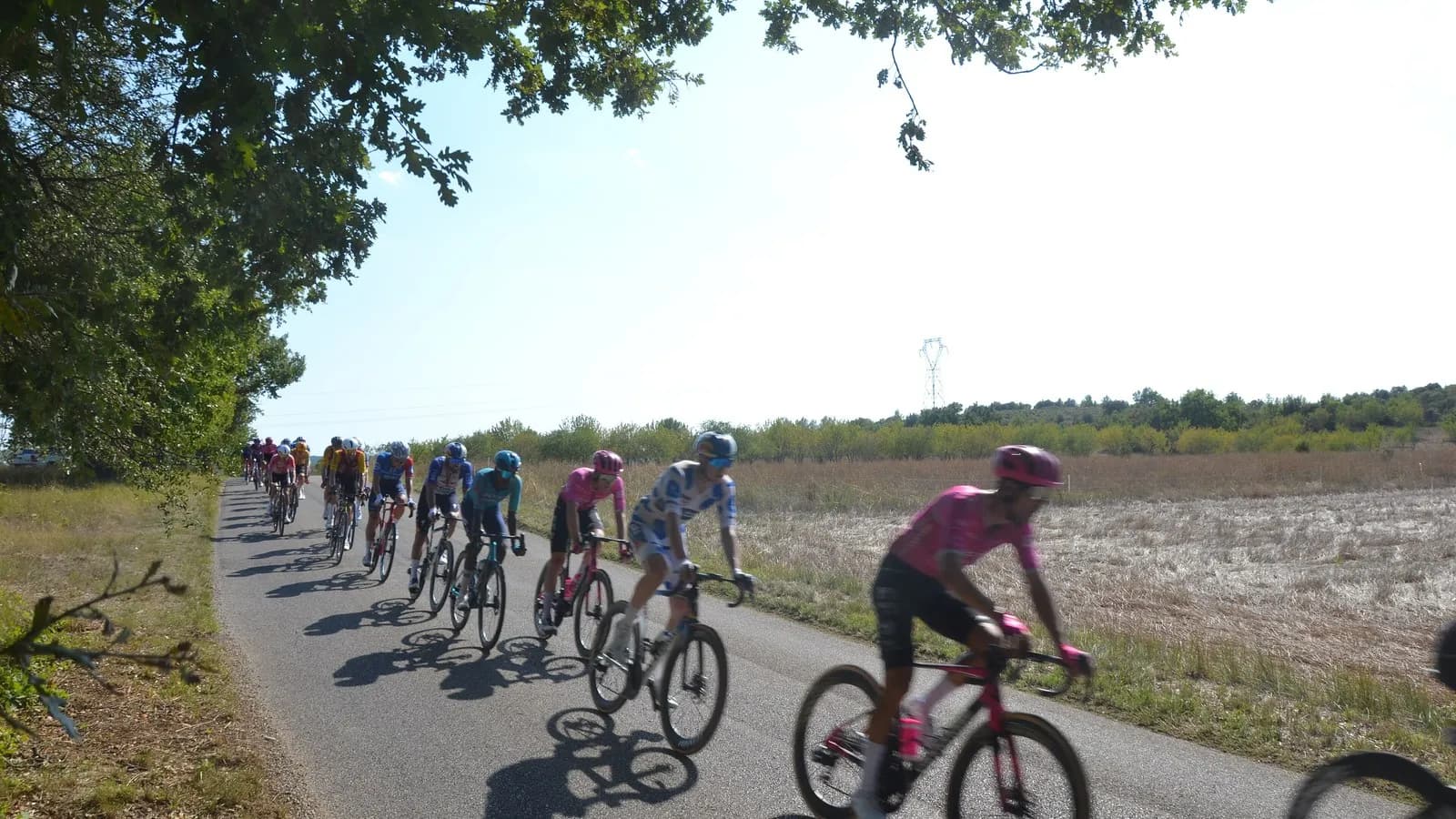 The chasing group strung out along a road on stage two of the 2026 Vuelta a Espana, between Esparron-de-Verdon and Greoux-les-Bains
