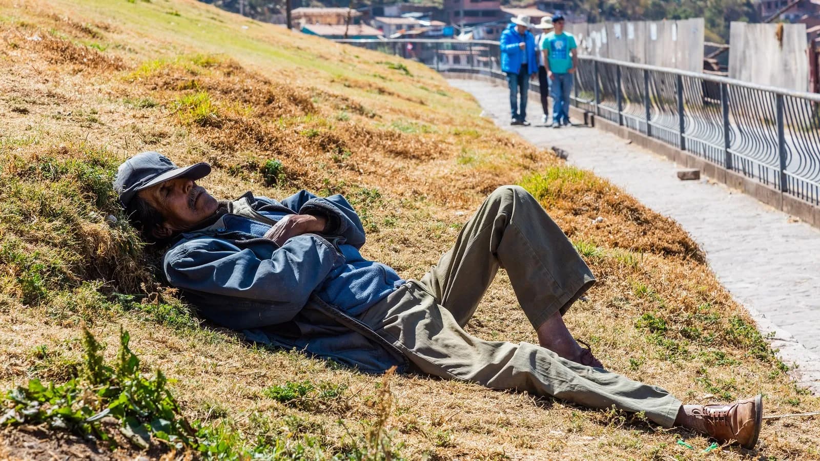 A man taking a siesta on a grassy bank in the San Cristobal district of Cusco, Peru, in July 2015