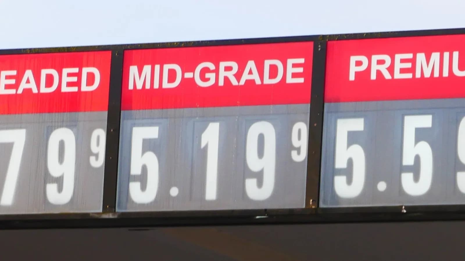 A petrol station price board in the United States showing regular, mid-grade and premium prices, photographed in April; the gasoline index has risen 27 per cent in a year