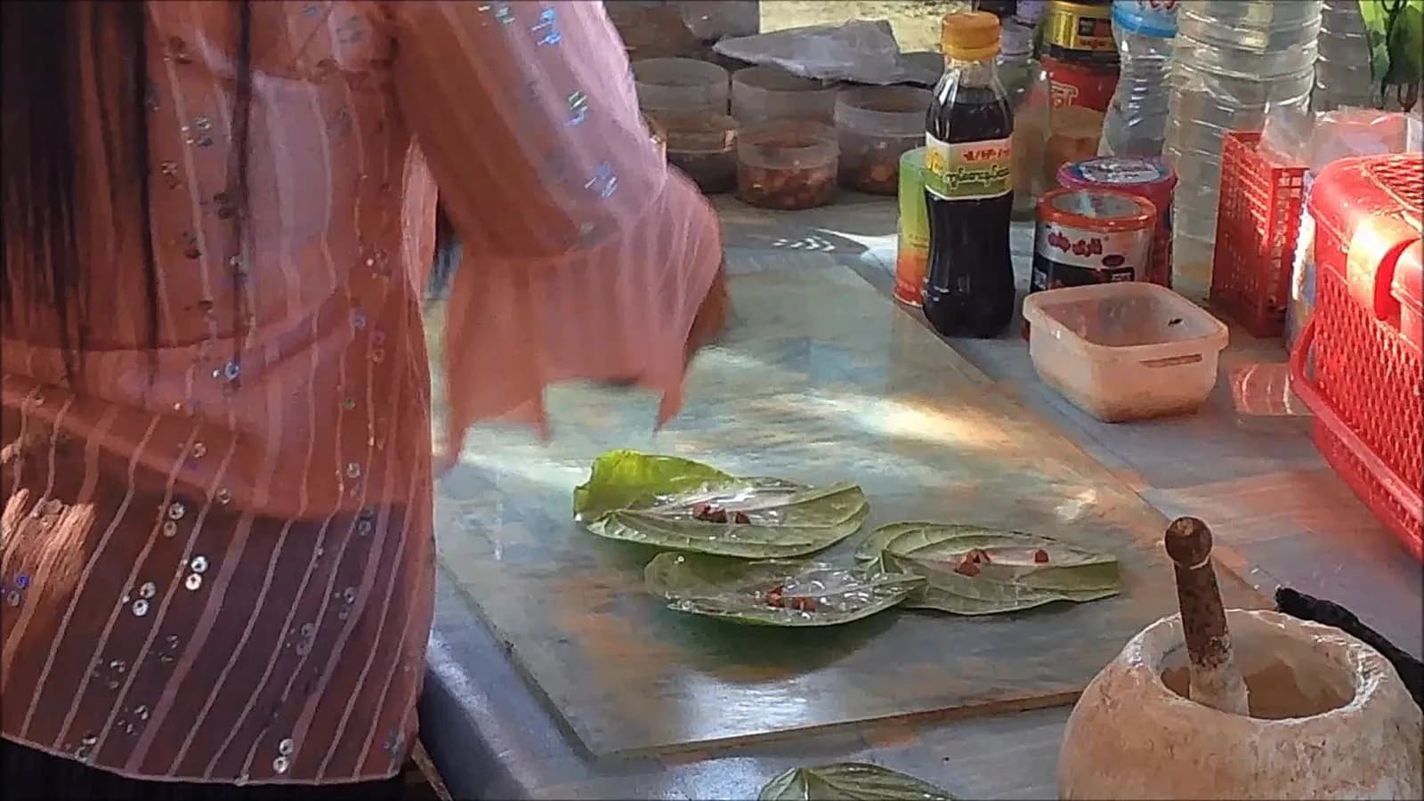 A woman preparing areca nut and betel leaf for chewing at a stall in Myanmar in 2014; the Sulawesi foragers sucked the nut rather than chewing a quid