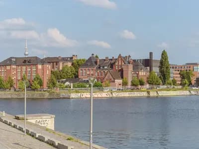 The red brick buildings of Campus Charite Mitte in Berlin seen across the Humboldthafen, photographed in 2024