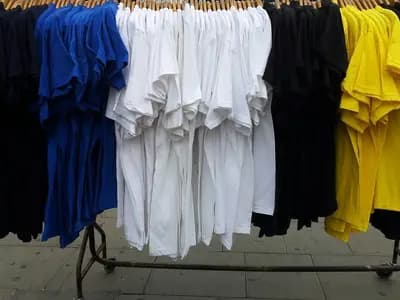 T shirts hanging on a clothes rail at a market stall