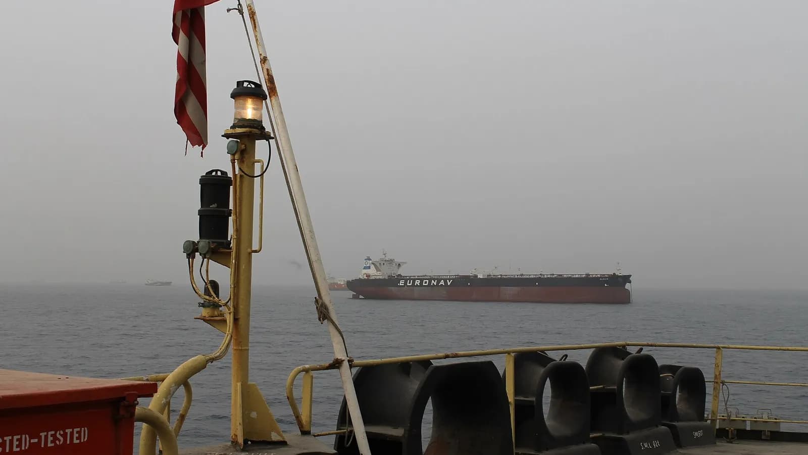 A Euronav oil tanker lying at anchor in haze off Fujairah, United Arab Emirates, seen from the deck of another ship, photographed on 21 March 2012, a file photograph of merchant shipping near the Strait of Hormuz and not of the GFS Pride or the Cape Dao