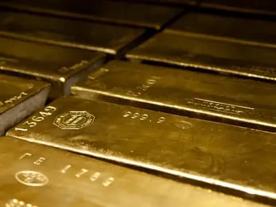 Four hundred ounce gold bars stamped 999.9 fine, stacked in a vault