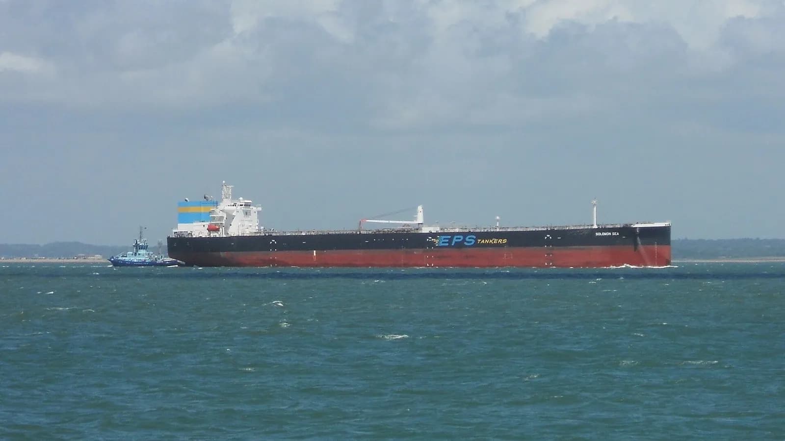 A large crude oil tanker with a tug alongside moving through coastal waters in the Solent, England, photographed on 11 June 2022, a file photograph illustrative of oil tankers and not of any vessel attacked near the Strait of Hormuz