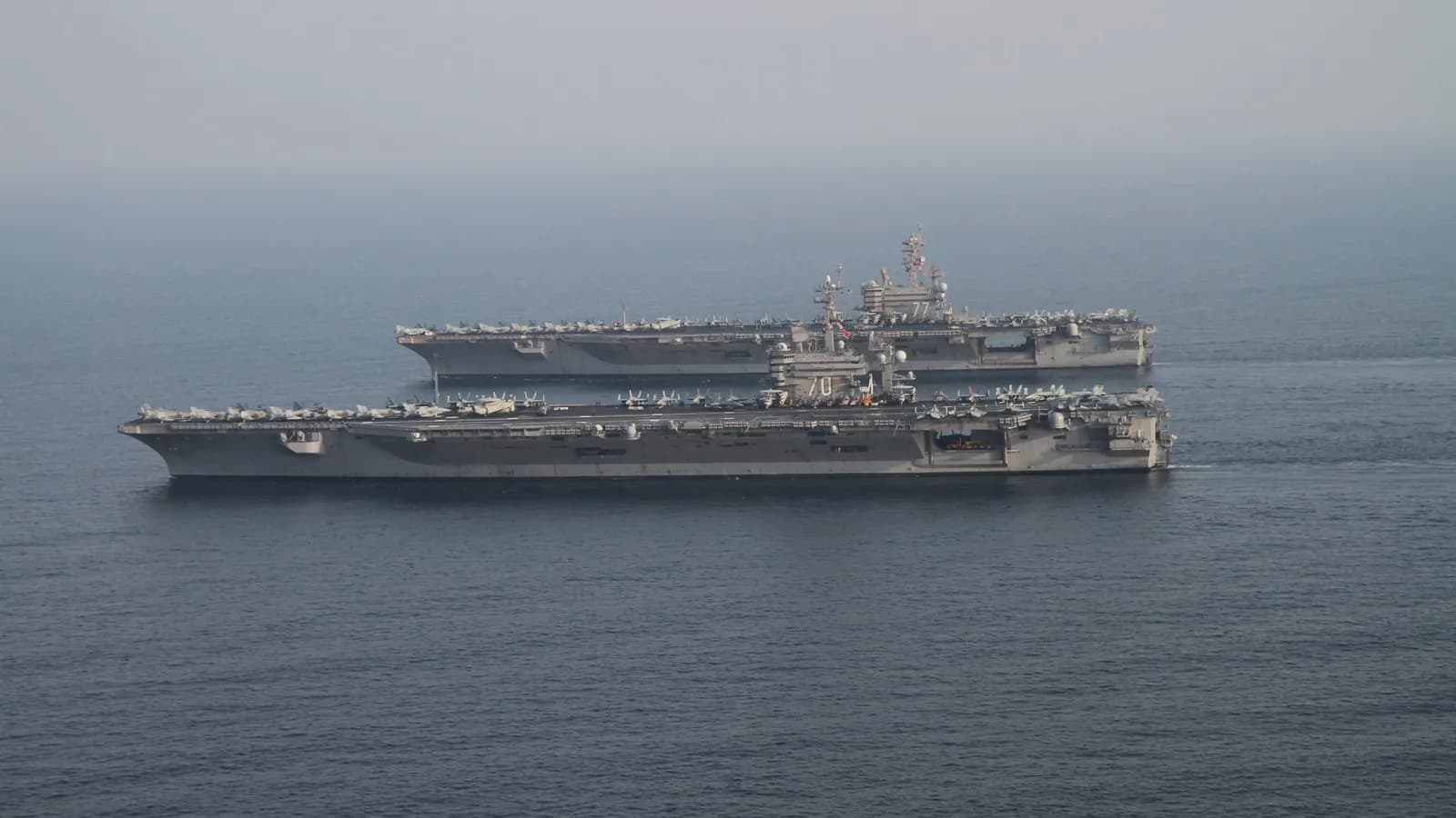 Two United States aircraft carriers in the Persian Gulf during a 2014 carrier relief, a file photograph illustrative of US naval power in the region and not of the current blockade