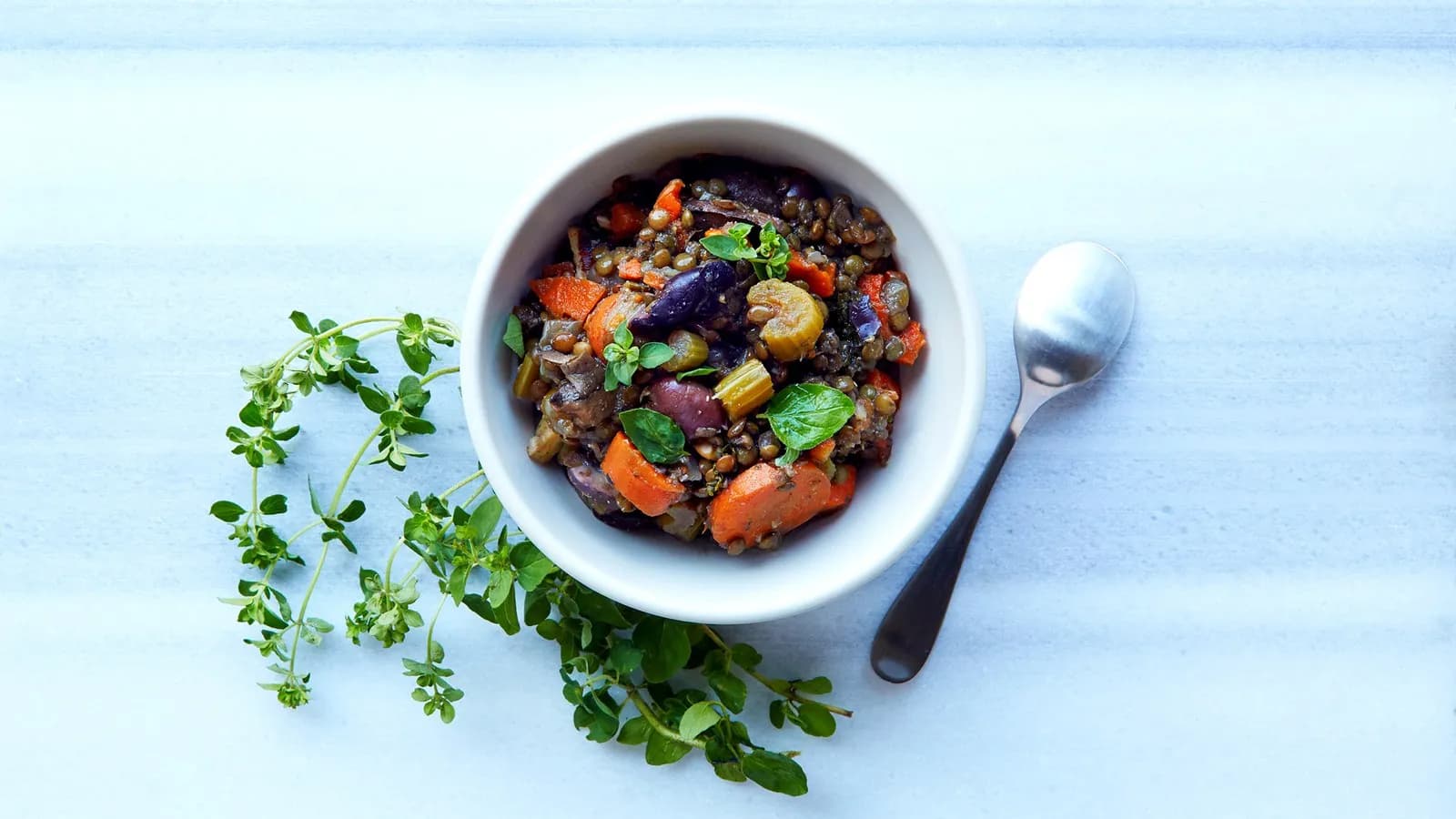 A bowl of lentils with roasted vegetables and greens, plant sources of non-haem iron
