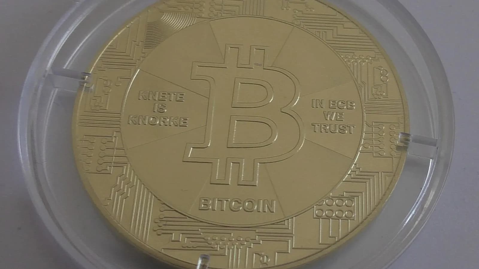 A gold-coloured physical bitcoin coin in a clear plastic case, photographed on 22 March 2020, a file photograph illustrative of bitcoin and not of JPMorgan's report