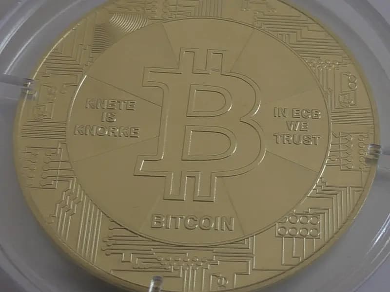 A gold-coloured physical bitcoin coin in a clear plastic case, photographed on 22 March 2020, a file photograph illustrative of bitcoin and not of JPMorgan's report