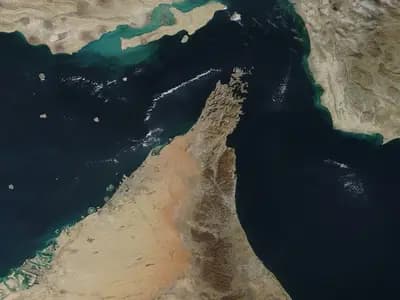 A satellite view of the Strait of Hormuz, with the bare mountains of the Musandam Peninsula jutting north into the channel between Oman and Iran