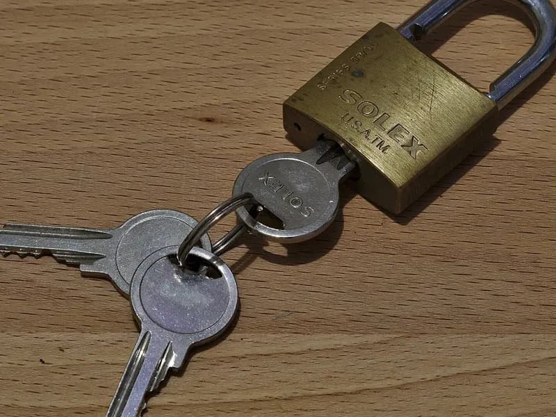A brass padlock beside a pair of keys on a wooden table, photographed on 16 January 2018, a file photograph illustrative of security and not of PHP or anything in the story