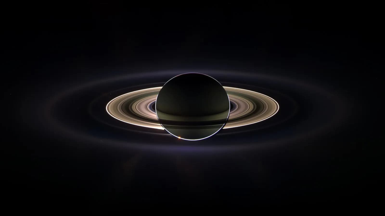Saturn eclipsing the Sun as seen by the Cassini spacecraft in September 2006, with the rings lit from behind, a spacecraft view and not what a telescope shows from Earth