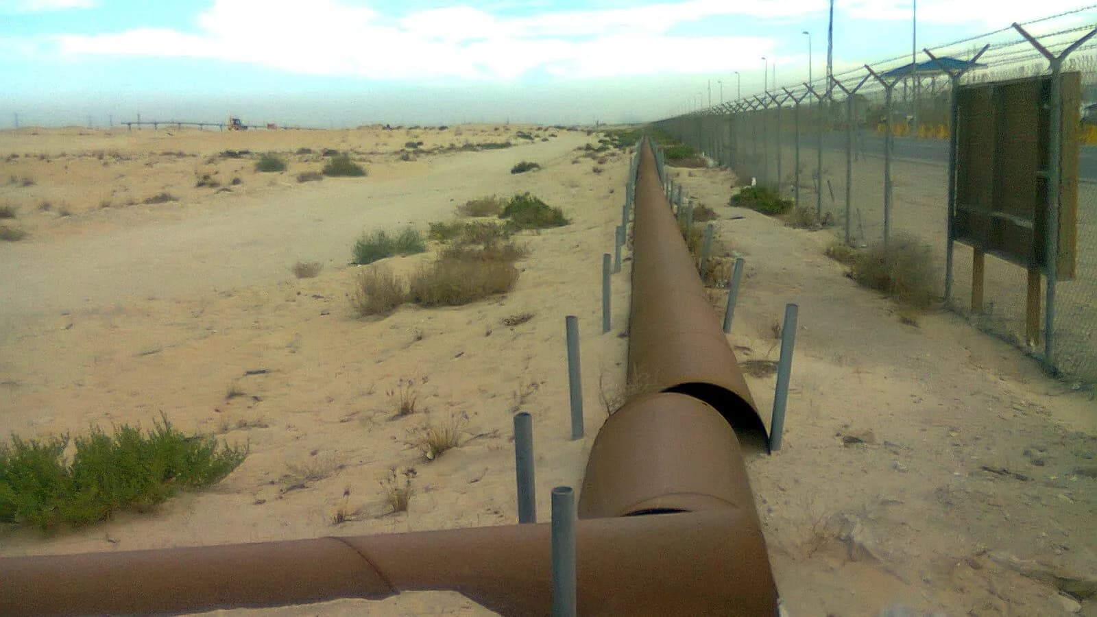 Oil pipelines running across the desert near Jubail in eastern Saudi Arabia, photographed in 2012; the East-West line begins at Abqaiq in the same province
