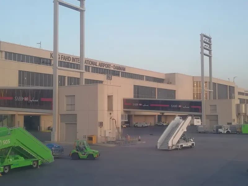 The passenger terminal of King Fahd International Airport in Dammam seen from the apron, with floodlight masts and ground-handling steps in the foreground, photographed on 13 March 2018, a file photograph of the airport and not of Wednesday's attack