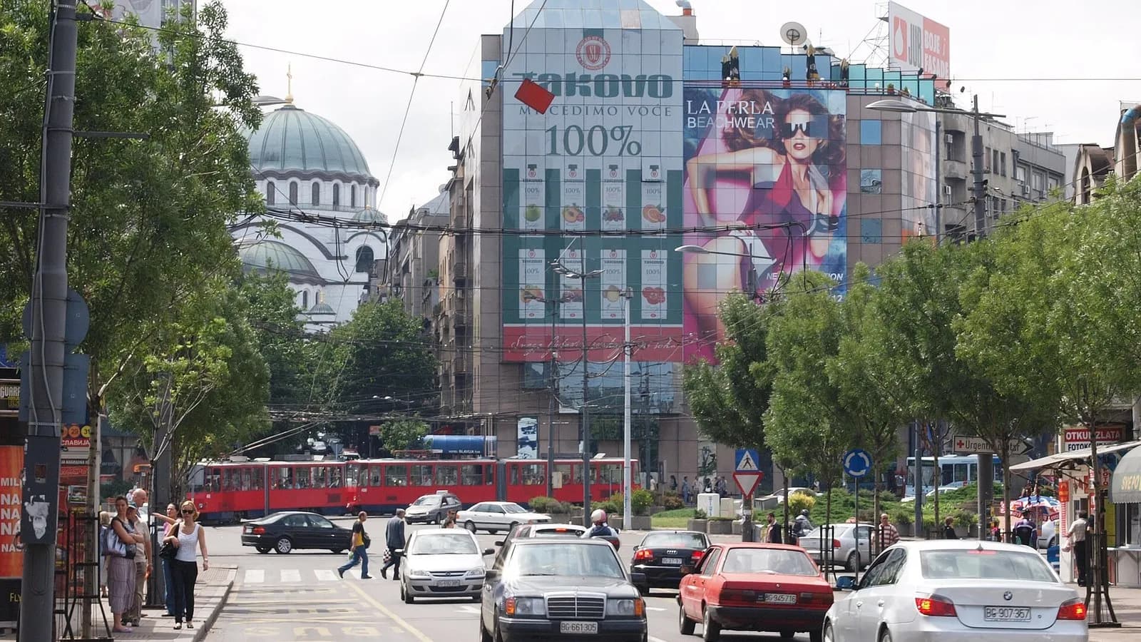Slavija Square in Belgrade with a red tram, a billboard-covered office block and the dome of the Church of Saint Sava behind it, photographed on 16 June 2009, a file photograph of the square where the rally was held and not of Thursday's crowd