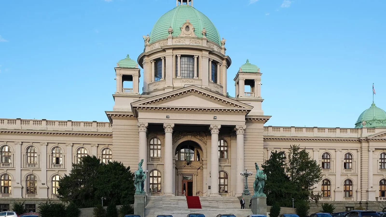 The pale stone House of the National Assembly of Serbia in Belgrade, with its green copper domes and columned portico under a blue sky, photographed on 6 November 2023, a file photograph of the parliament building and not of this week's election or its count
