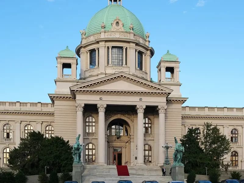 The pale stone House of the National Assembly of Serbia in Belgrade, with its green copper domes and columned portico under a blue sky, photographed on 6 November 2023, a file photograph of the parliament building and not of this week's election or its count