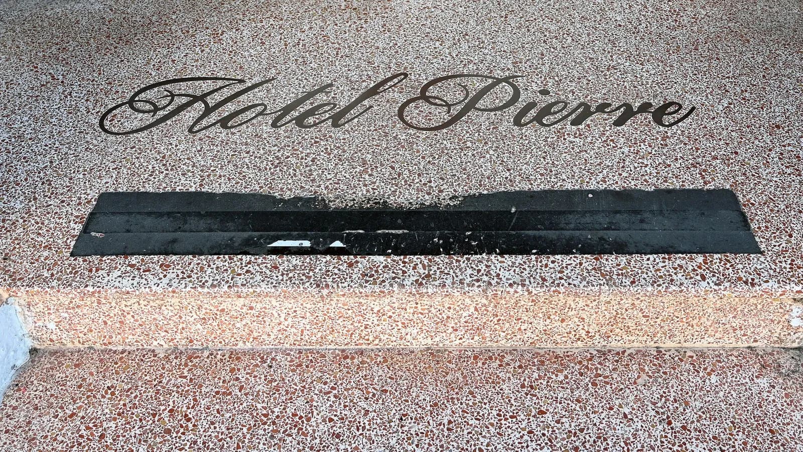 A terrazzo entrance floor with the name Hotel Pierre set into it, on Miami Beach, photographed in 2025