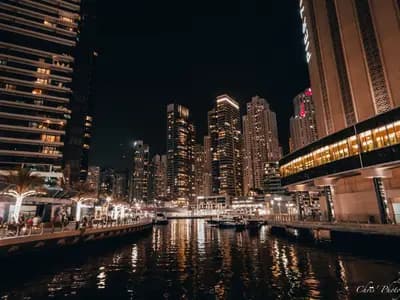 The Dubai skyline at dusk with illuminated skyscrapers, representing the UAE's push into regulated digital currency