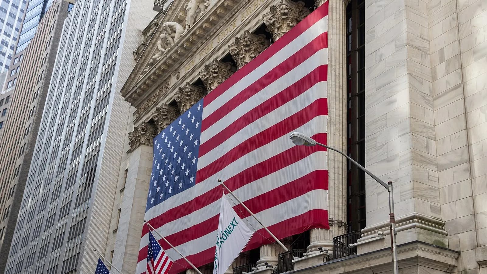The facade of the New York Stock Exchange on Wall Street in New York City with a large American flag, photographed in July 2012, a file photograph and not from Monday's trading