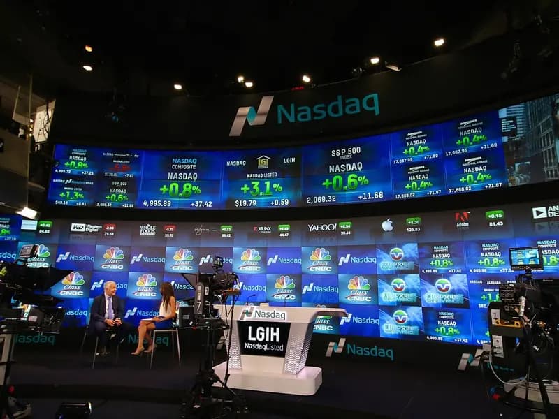 The curved wall of screens in the Nasdaq MarketSite broadcast studio in Times Square with presenters at a desk, photographed on 30 June 2015, a file photograph of the studio and not of Thursday's trading